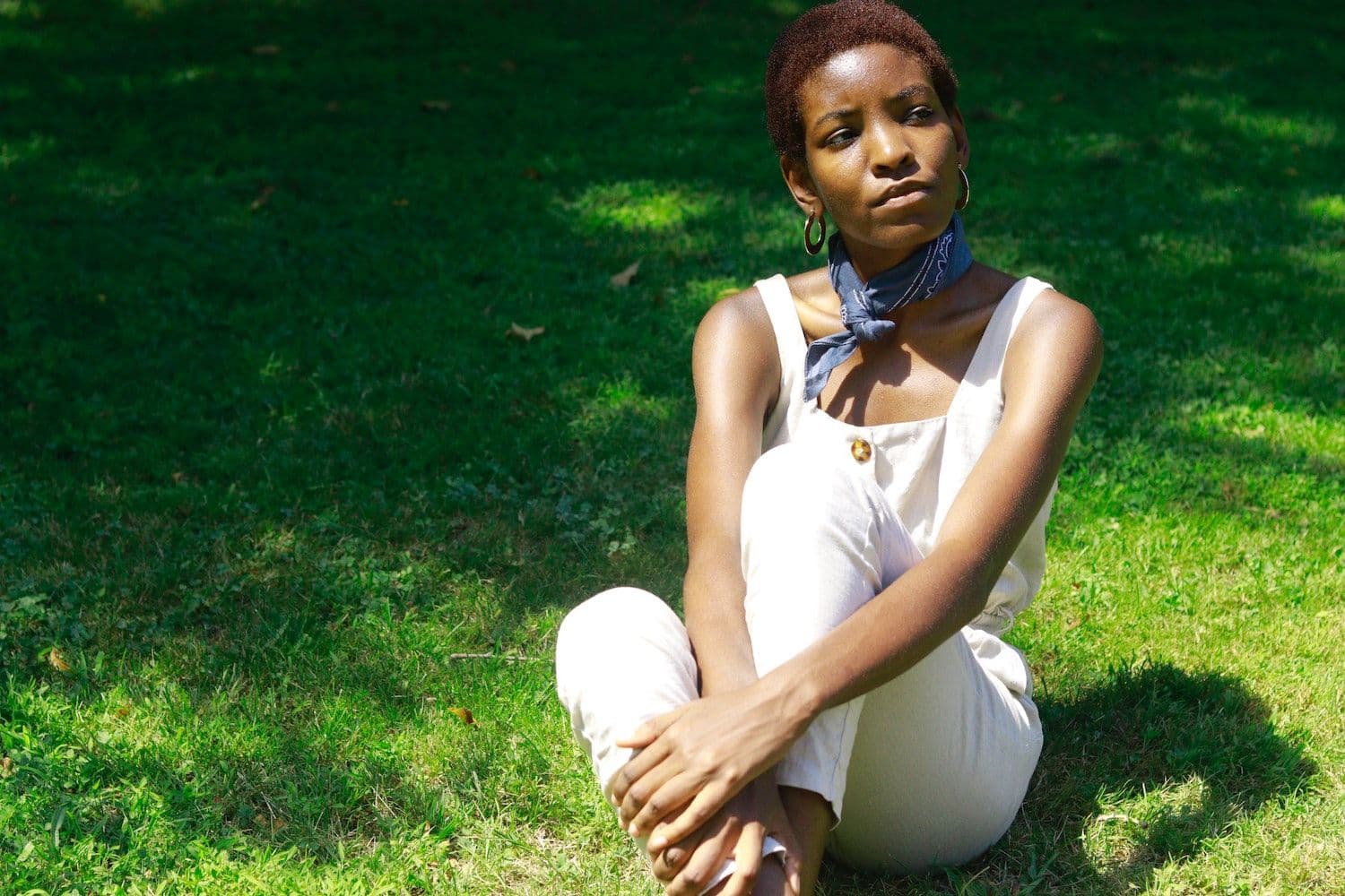 Woman sat on grass. 