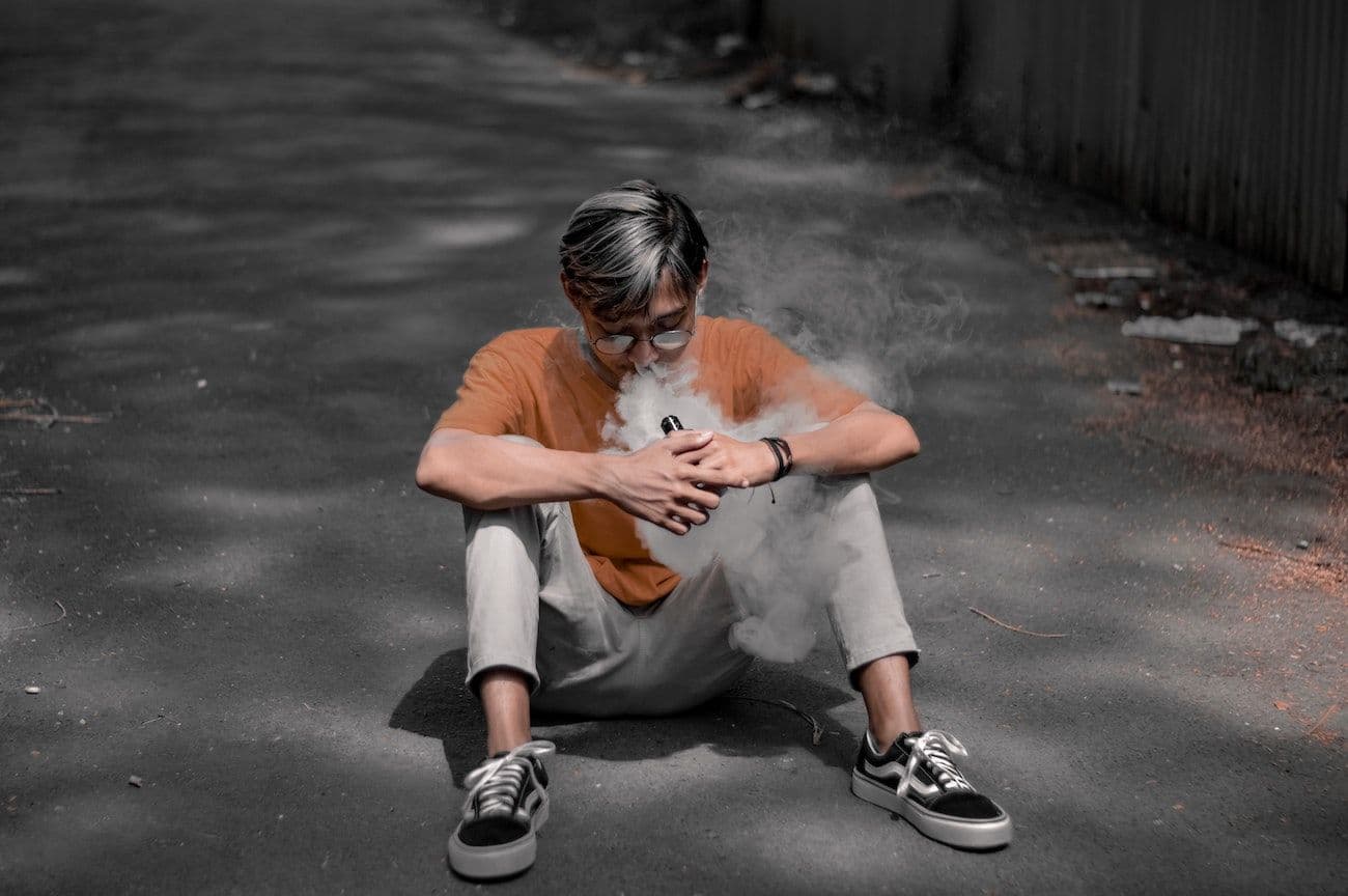 Young man smoking a vape