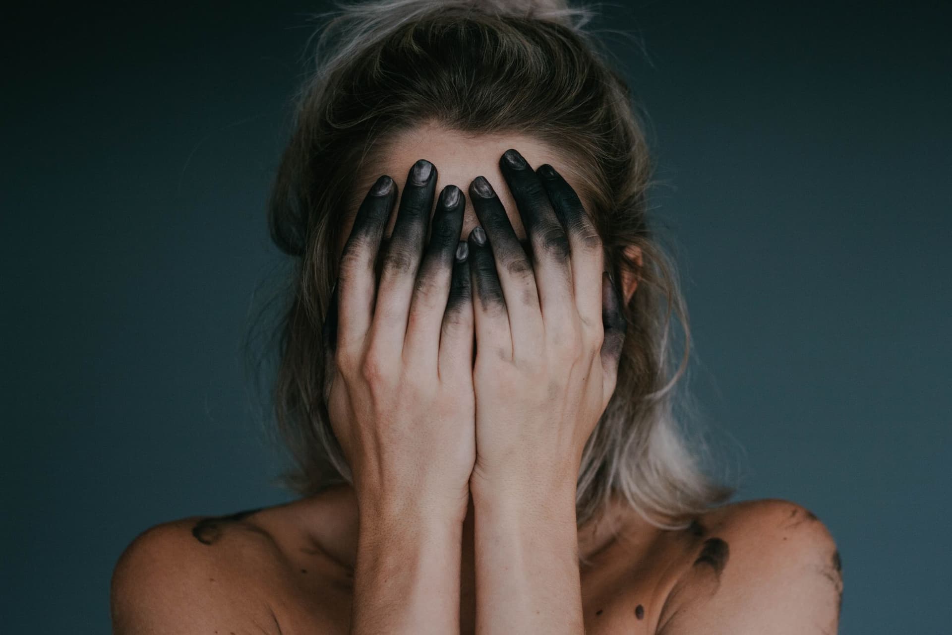 Woman with hands over face