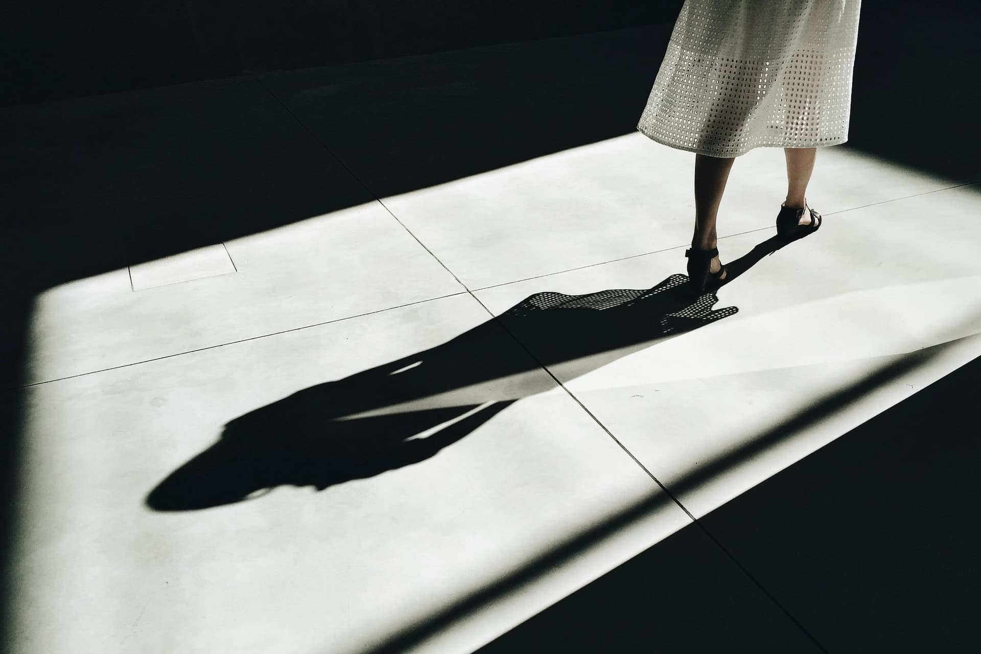 Women in white room with visible shadow