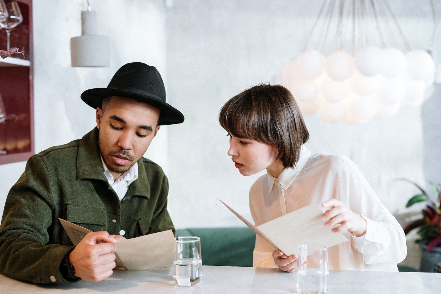 Man and woman looking at menu in a cafe
