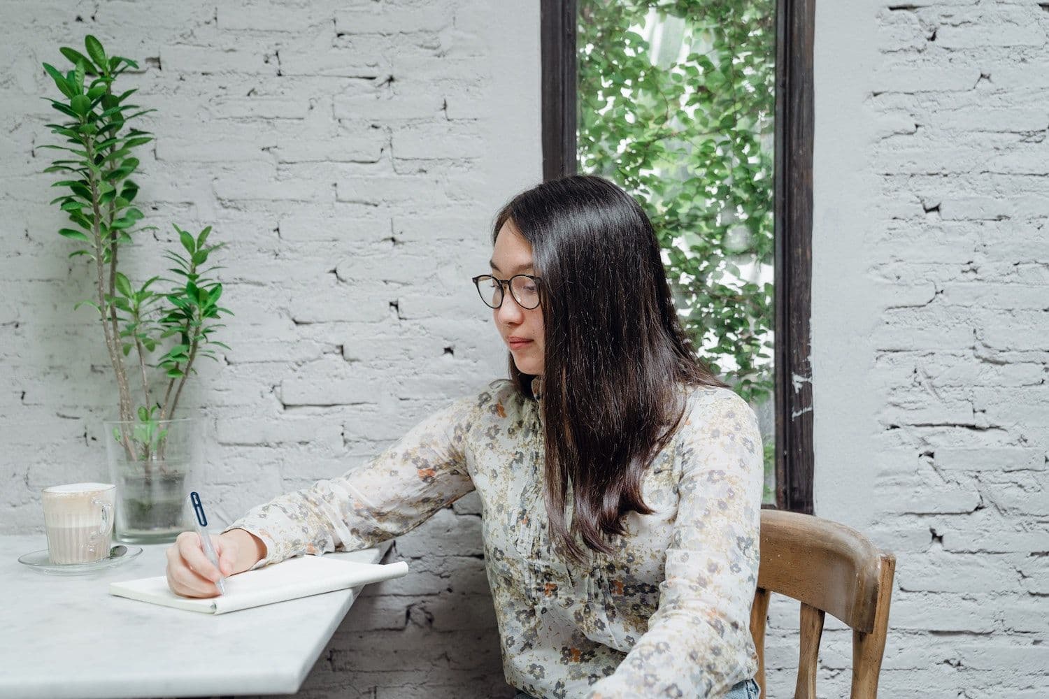 Woman writing in cafe