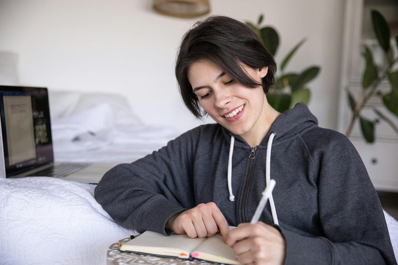 Smiling woman writing