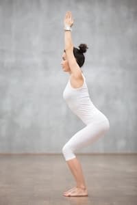 This is a photo of a lady doing the chair pose