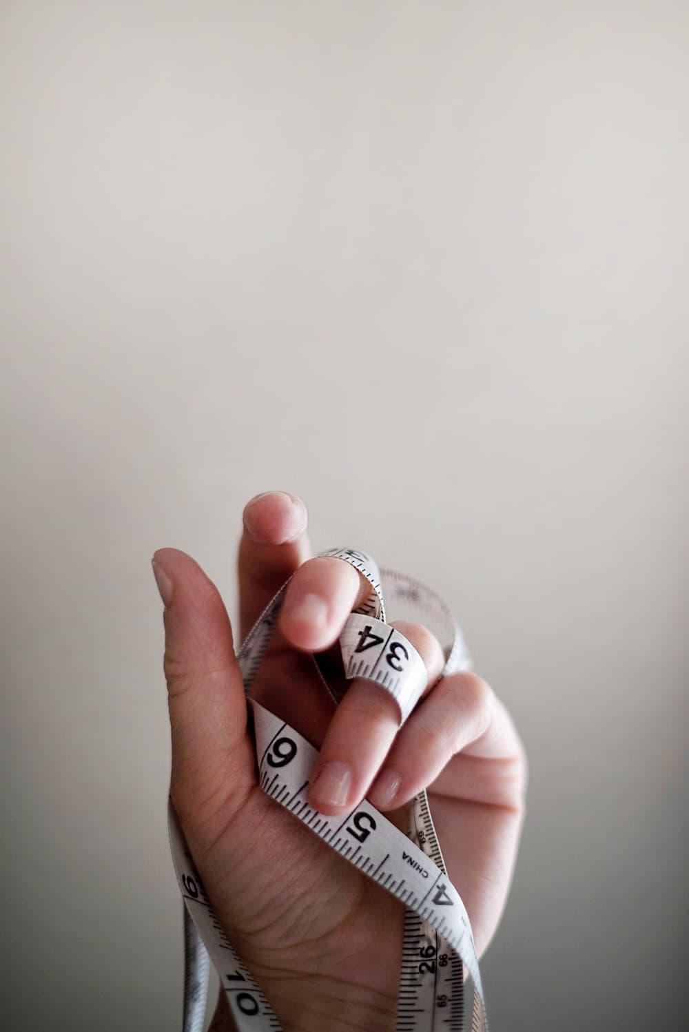 hand holding tape measure