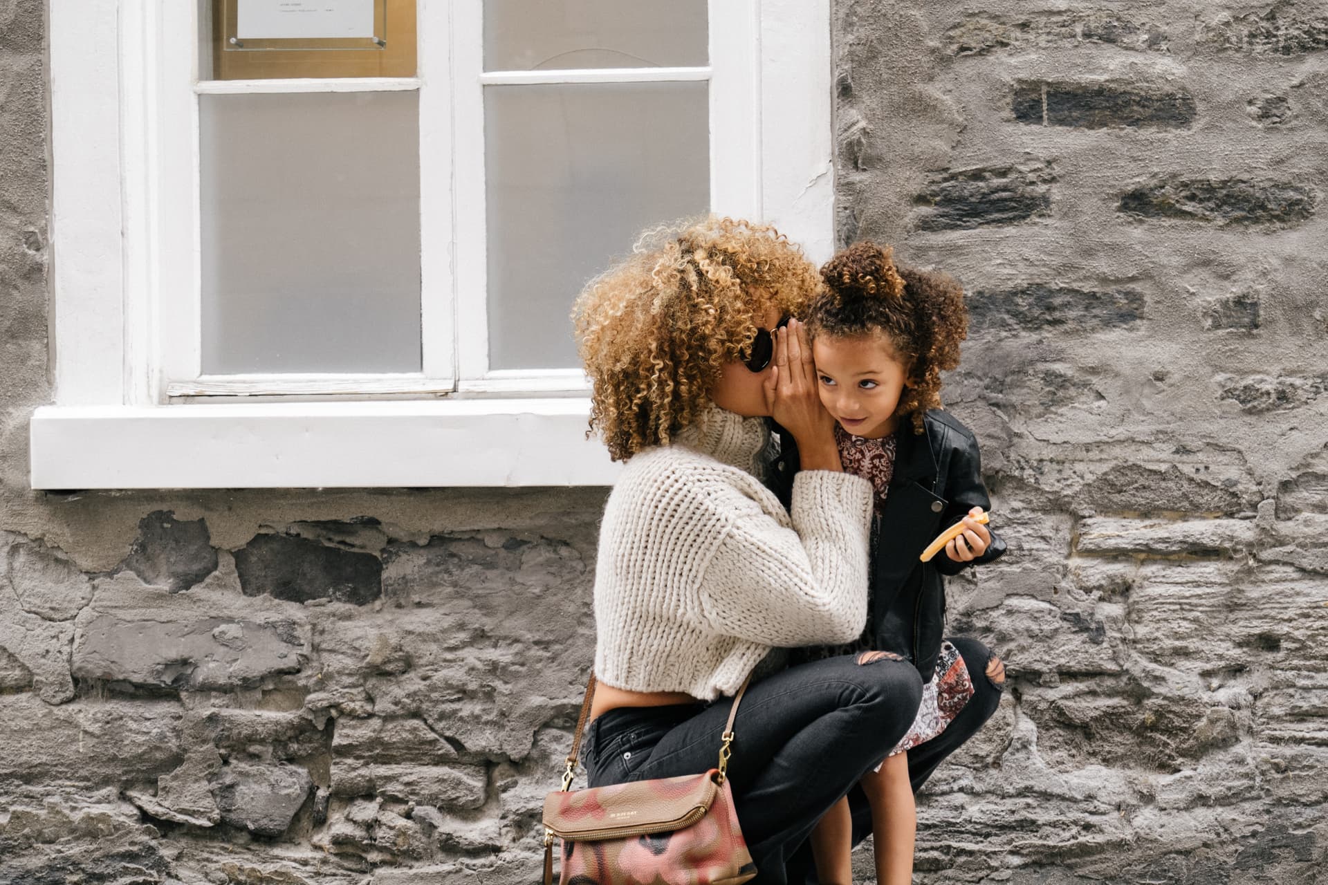 mum-whispering-to-daughter