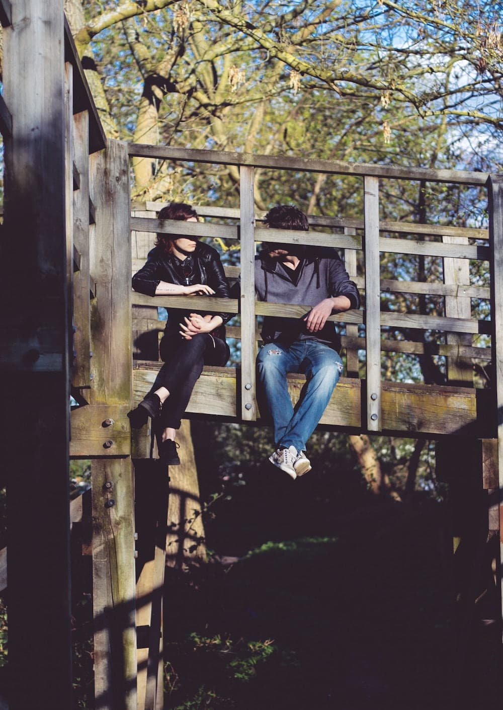 couple sitting on bridge