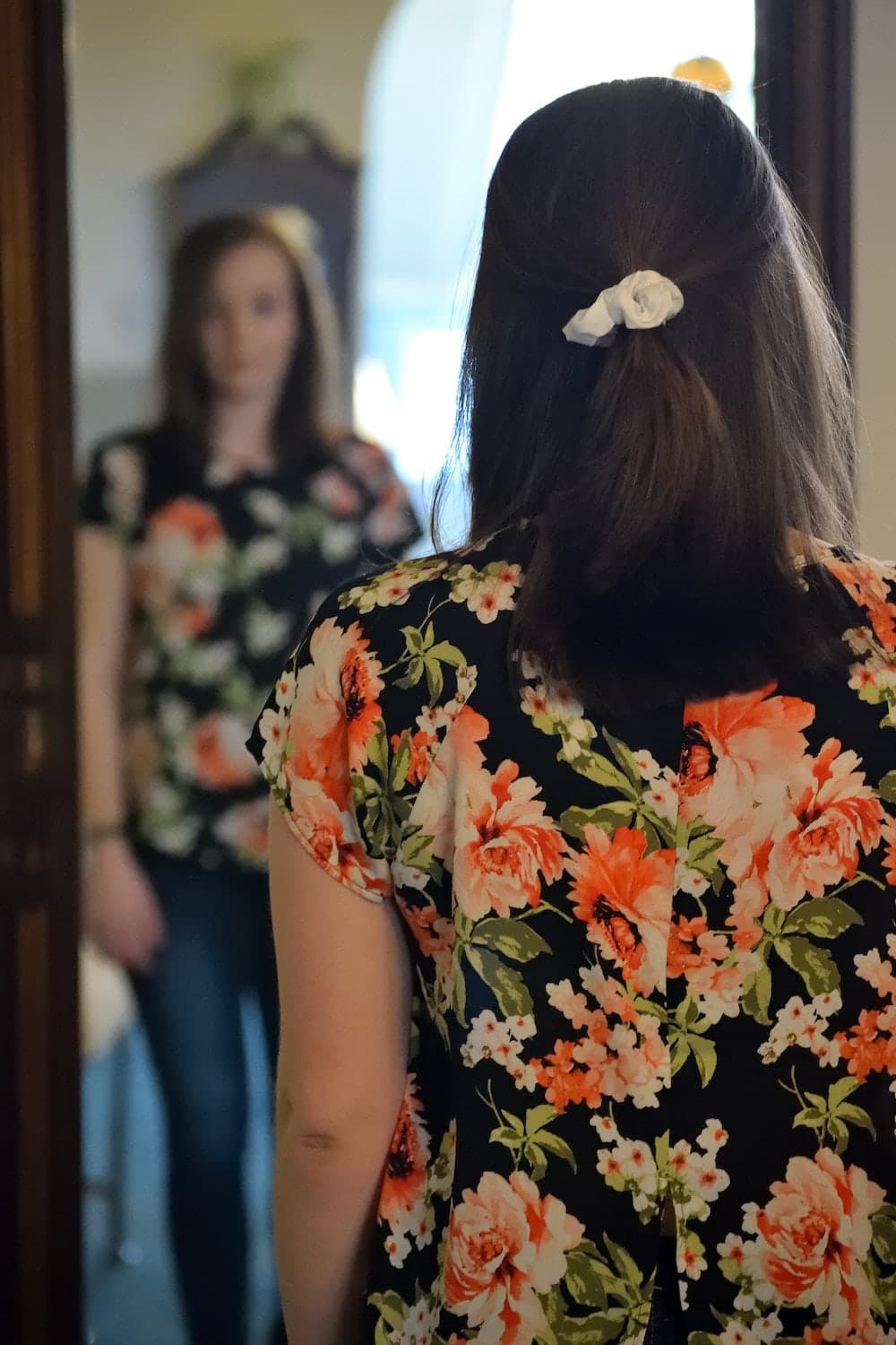 woman looking in mirrow