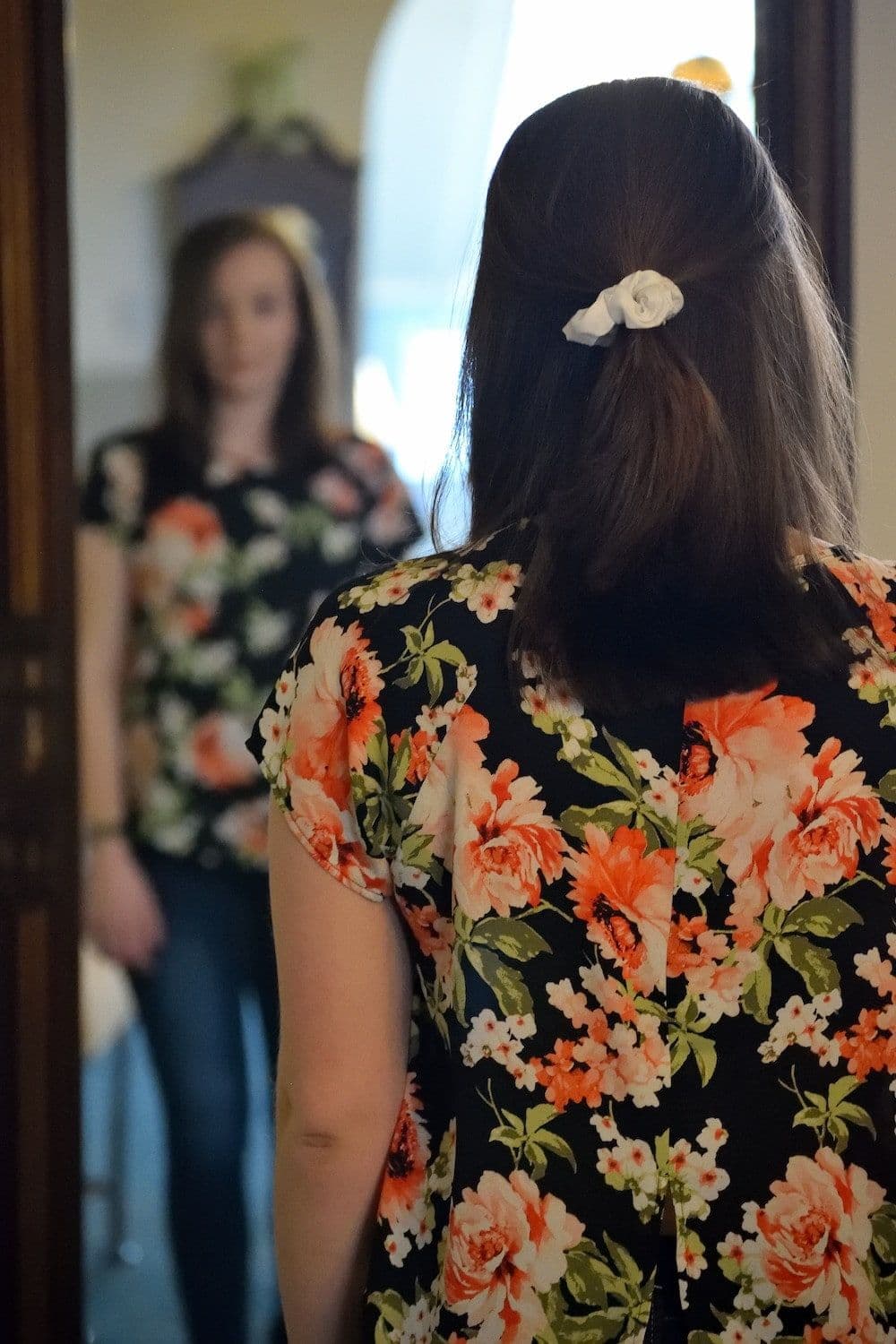 woman looking in mirror