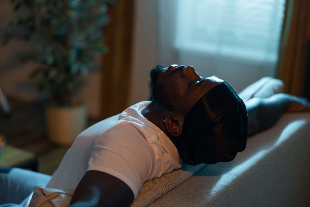 Man lying back on sofa