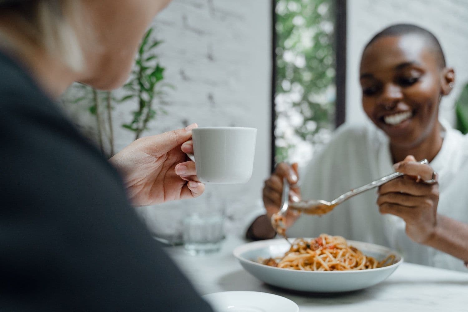 Friends eating pasta